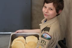 A Scout with a tray of pancakes