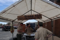 Adults cooking pancakes under the shelter