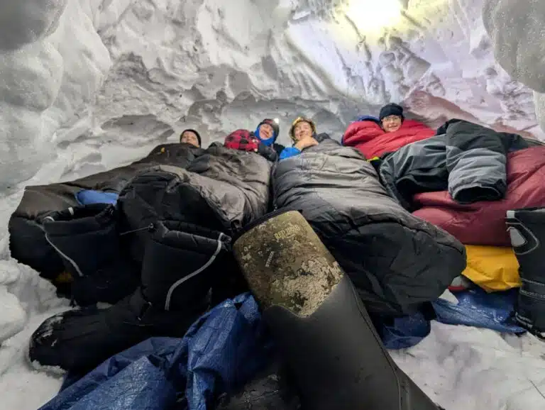 A group of 4 Scouts sleeping in a snow cave.